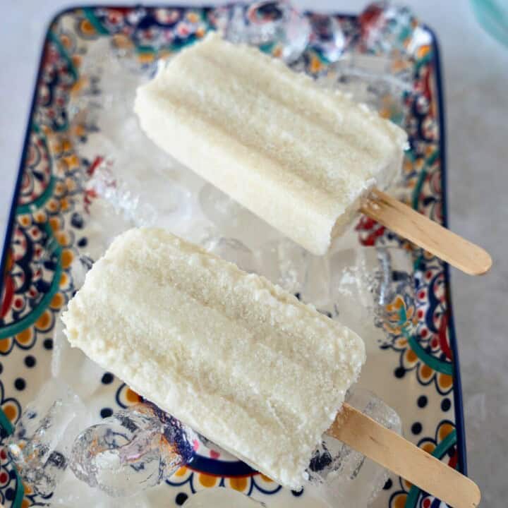 Feature image of paletas de coco on a plate.
