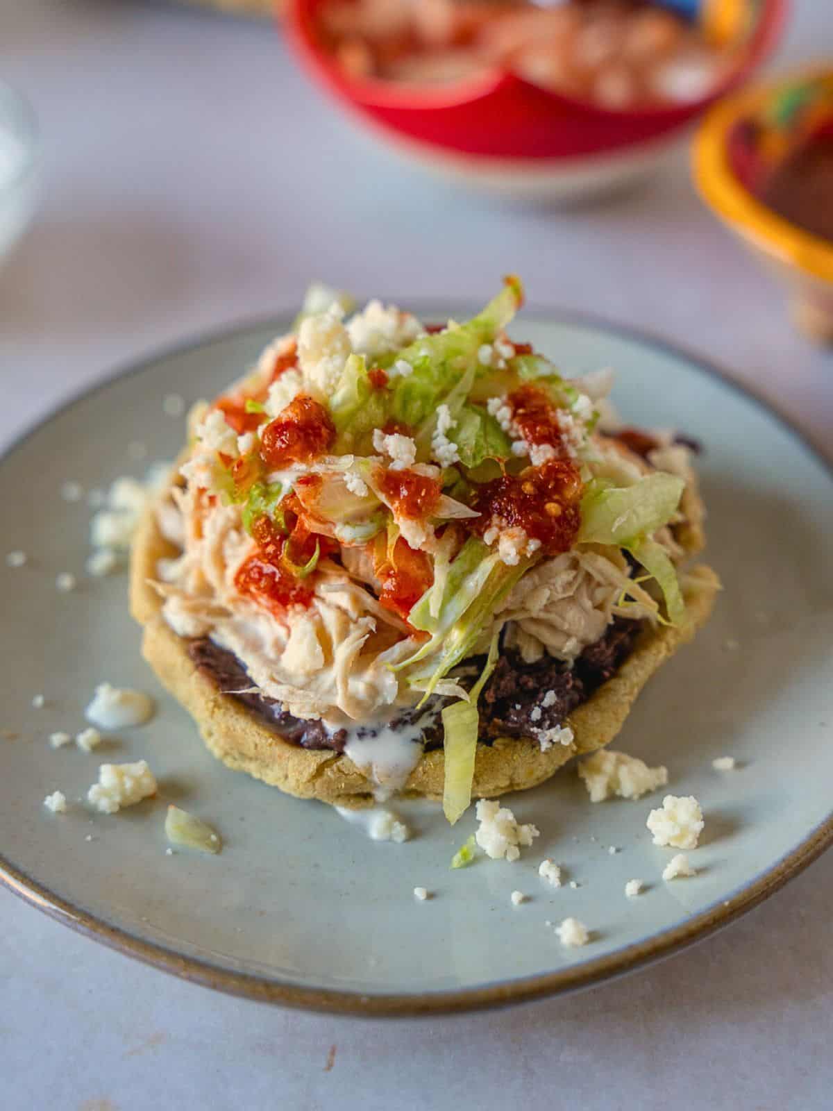 Sope de pollo on a plate.