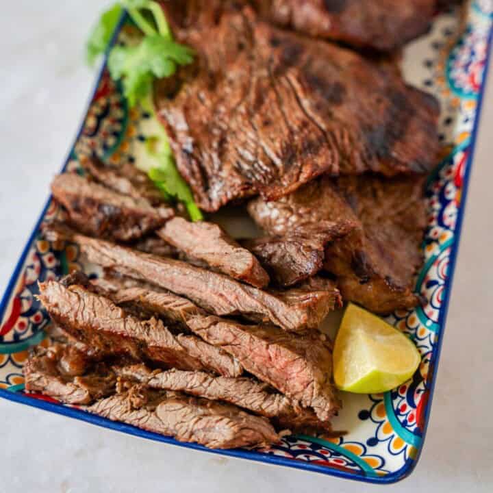 Feature image of sliced carne asada on a plate.
