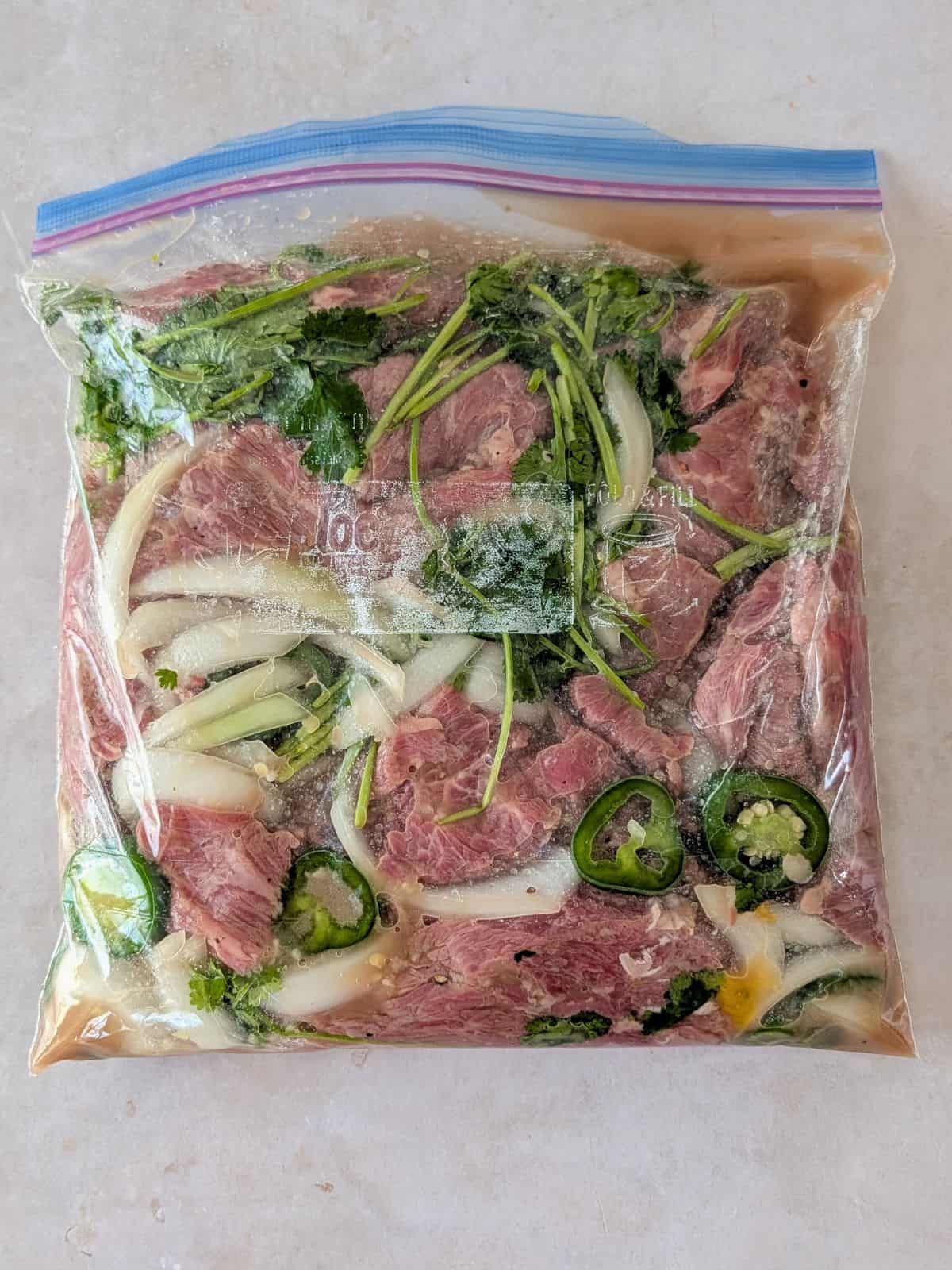 Meat in a zip top bag with the marinade inside.