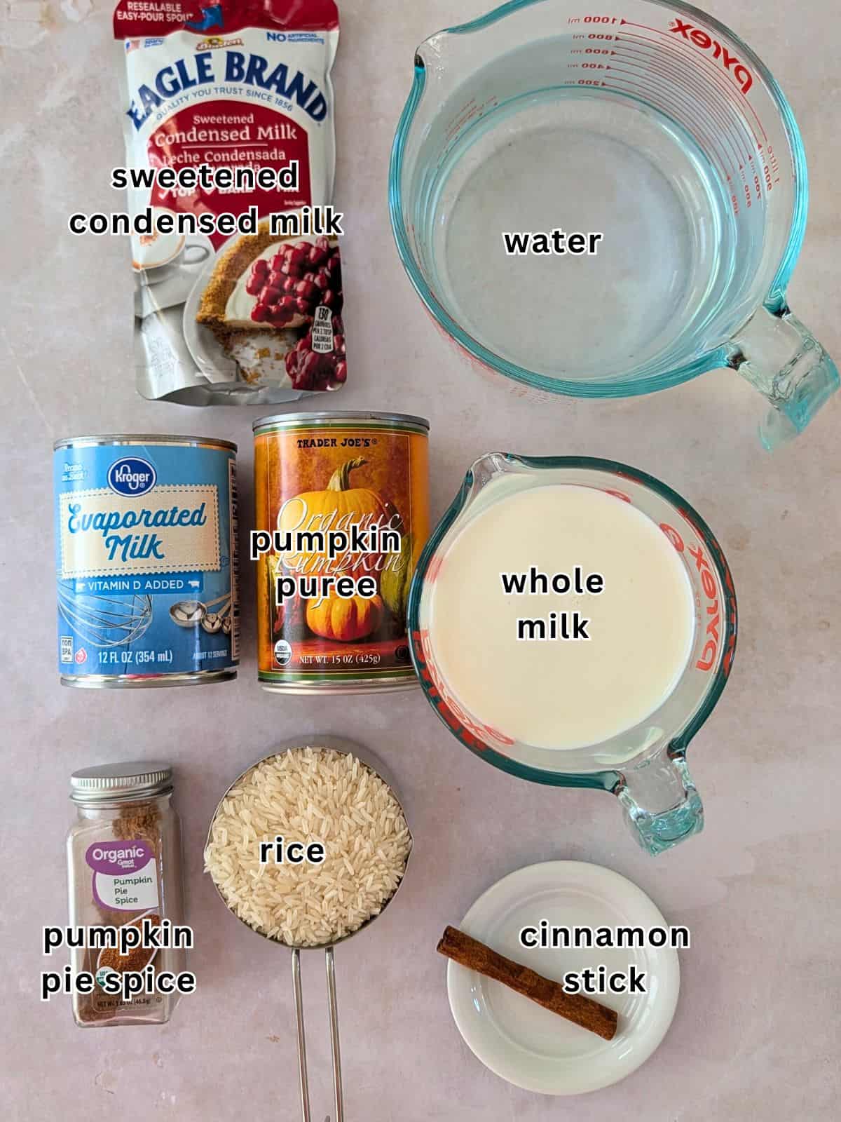 Ingredients with text- sweetened condensed milk, water, evaporated milk, pumpkin puree, whole milk, rice, cinnamon stick, and pumpkin spice.