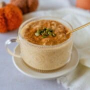Feature image of pumpkin arroz con leche in a glass cup.