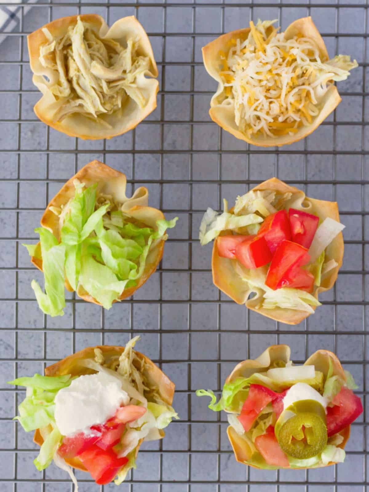 Overhead view of taco wonton cups being assembled on a baking tray.