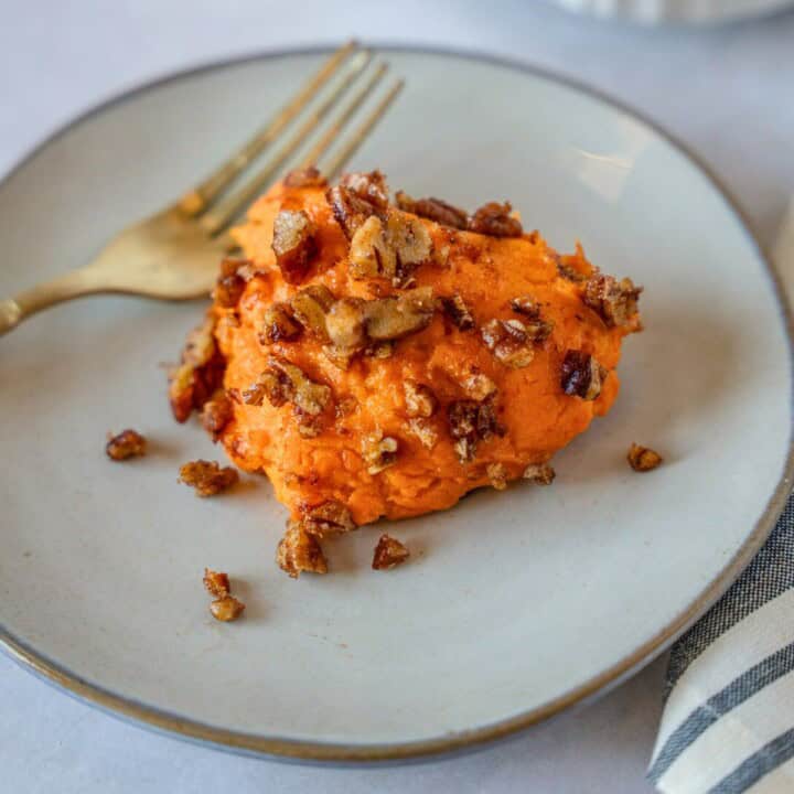 Feature image of sweet potato casserole on a plate with a fork.