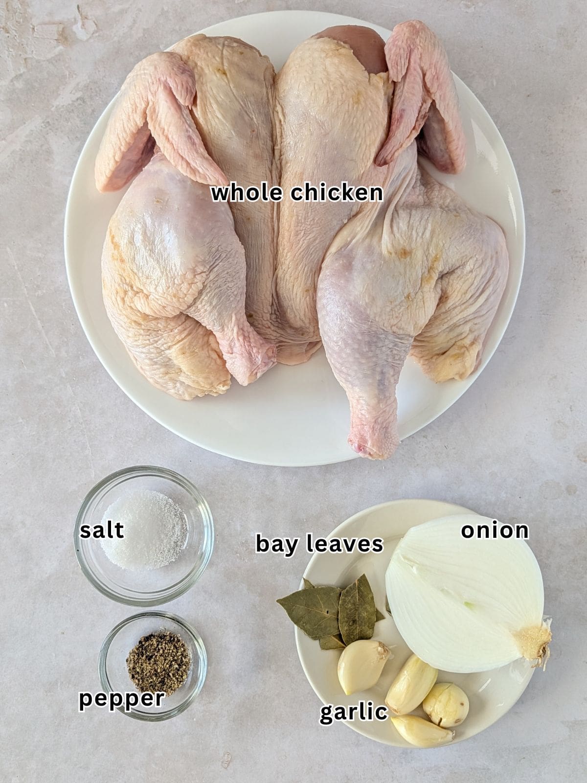 Whole chicken, salt, pepper, bay leaves, onion, and garlic.