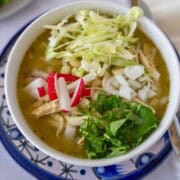 Feature image of pozole verde with chicken and toppings.