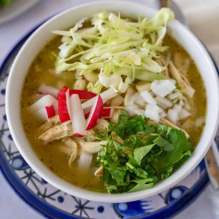 Feature image of pozole verde with chicken and toppings.