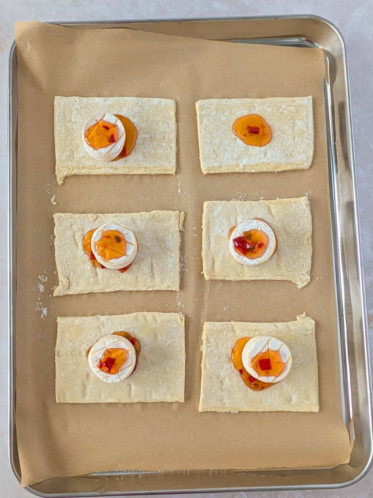 Puff pastry squares with brie and hot pepper jelly.