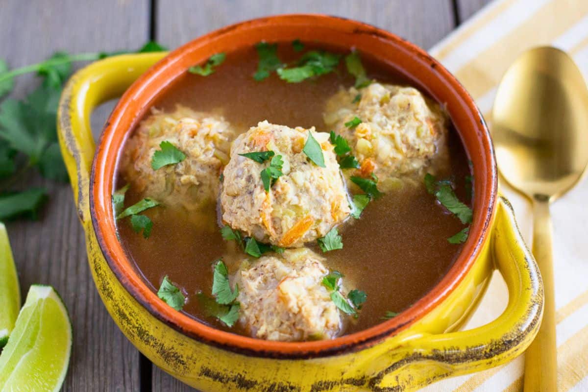 Chicken albondigas in a yellow bowl.