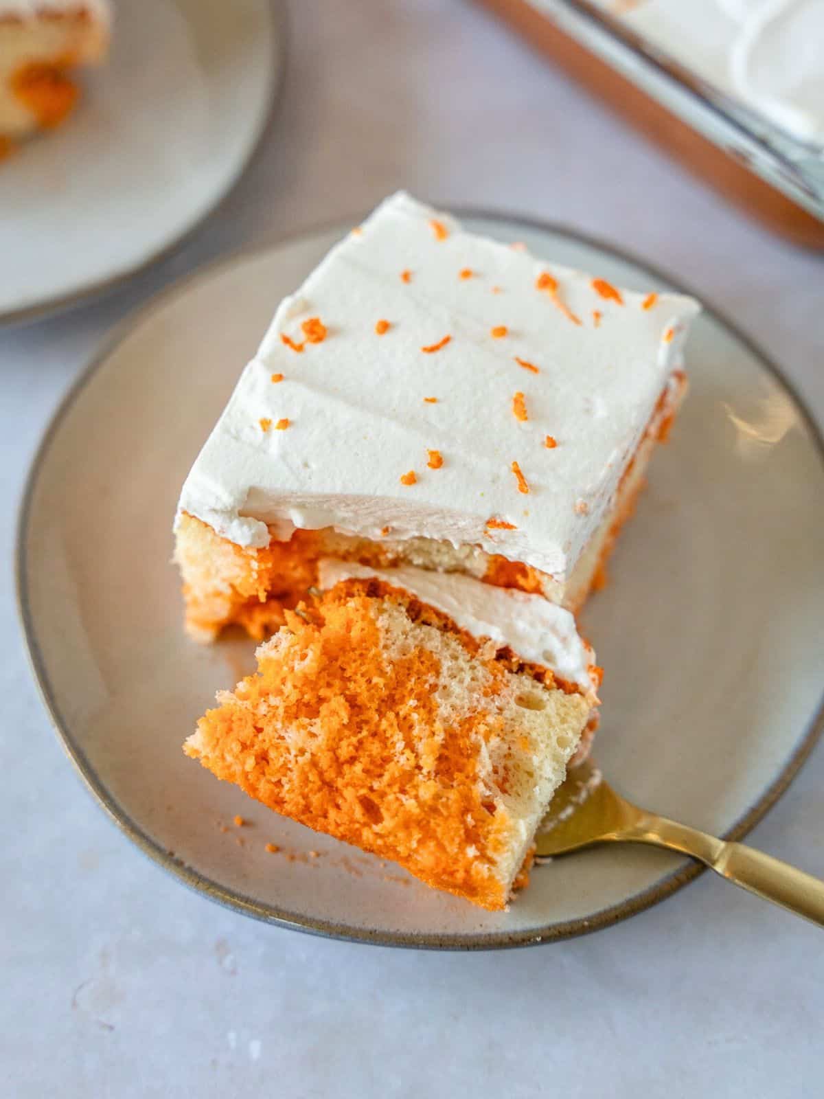 Slice of Thai tea tres leches cake with a piece on a fork.