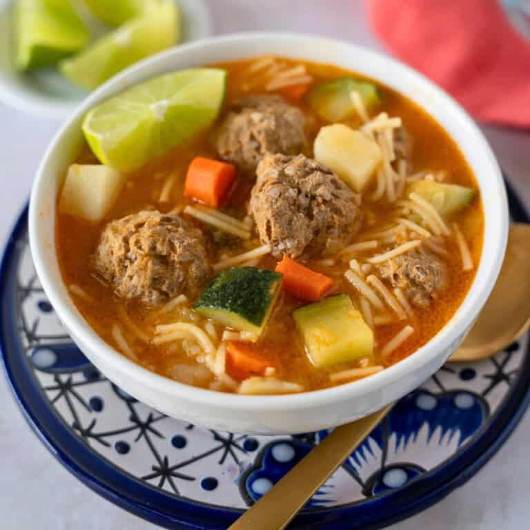Feature image of sopa de albondigas con fideo in a bowl.