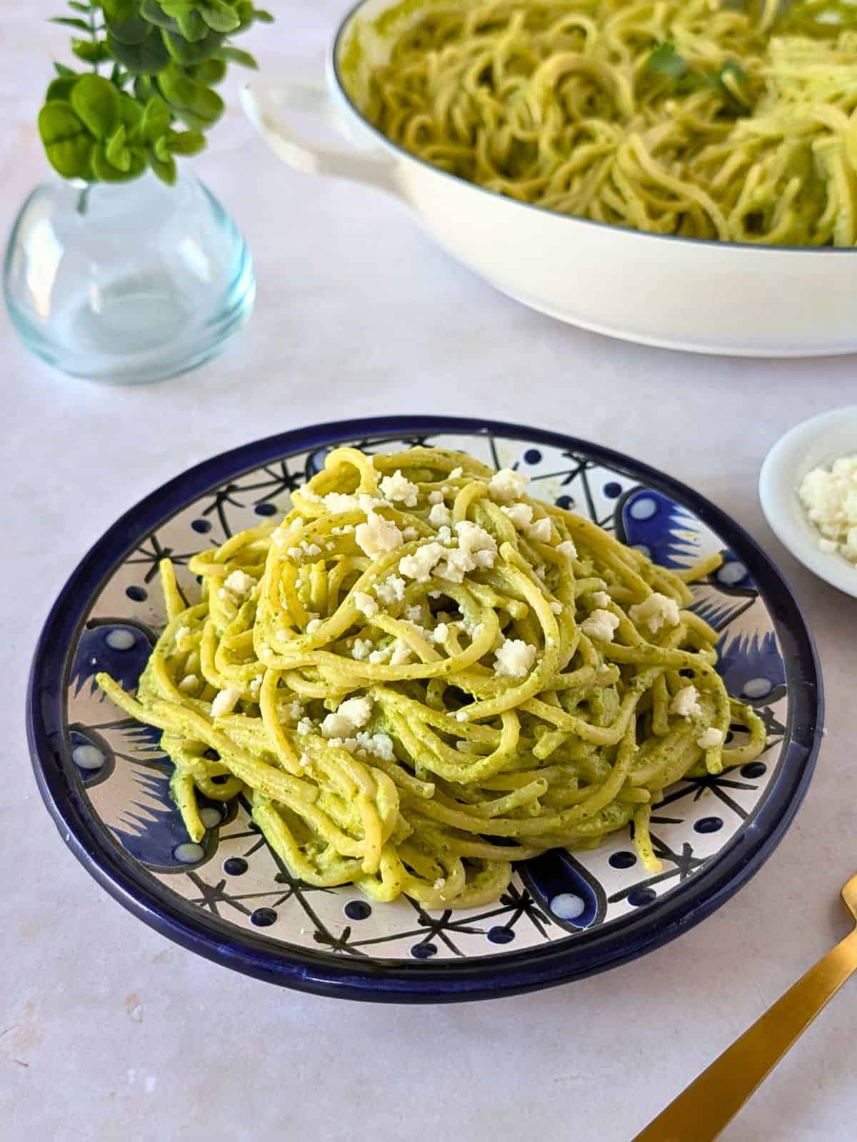 Mexican green spaghetti on a blue plate.