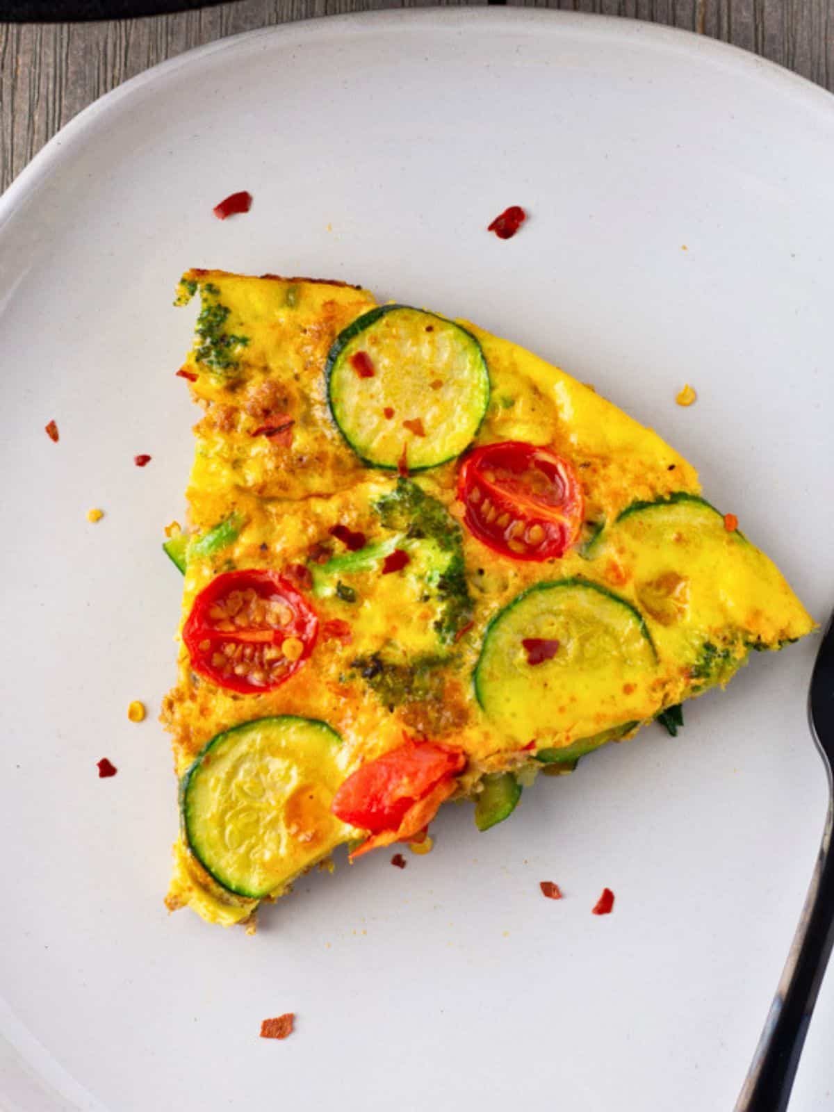 Slice of frittata on a plate.