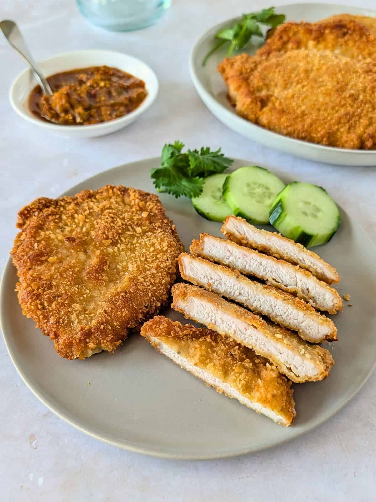 Sliced pork milanesa on a plate.
