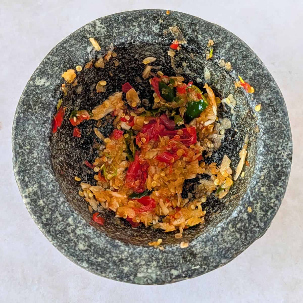 Pounded garlic and chilies in a mortar.