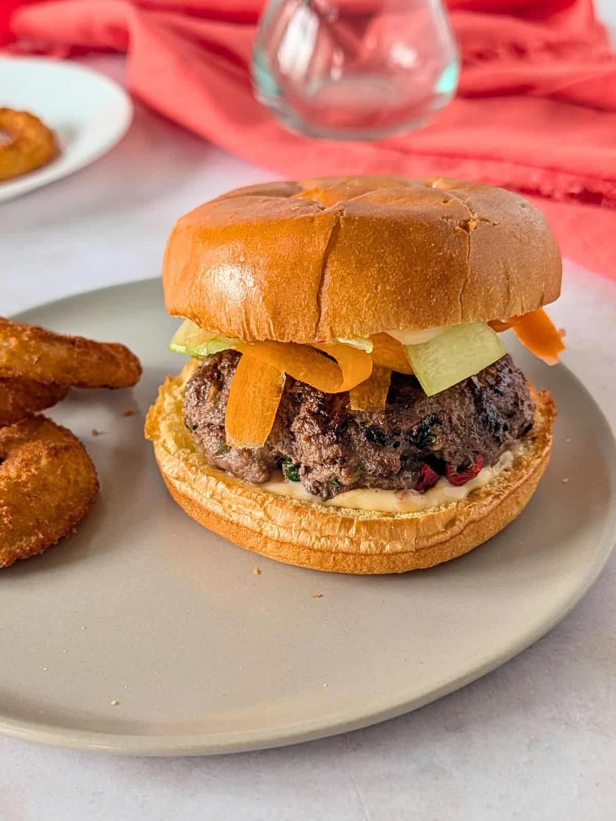 Thai Burger topped with carrots and cucmbers.