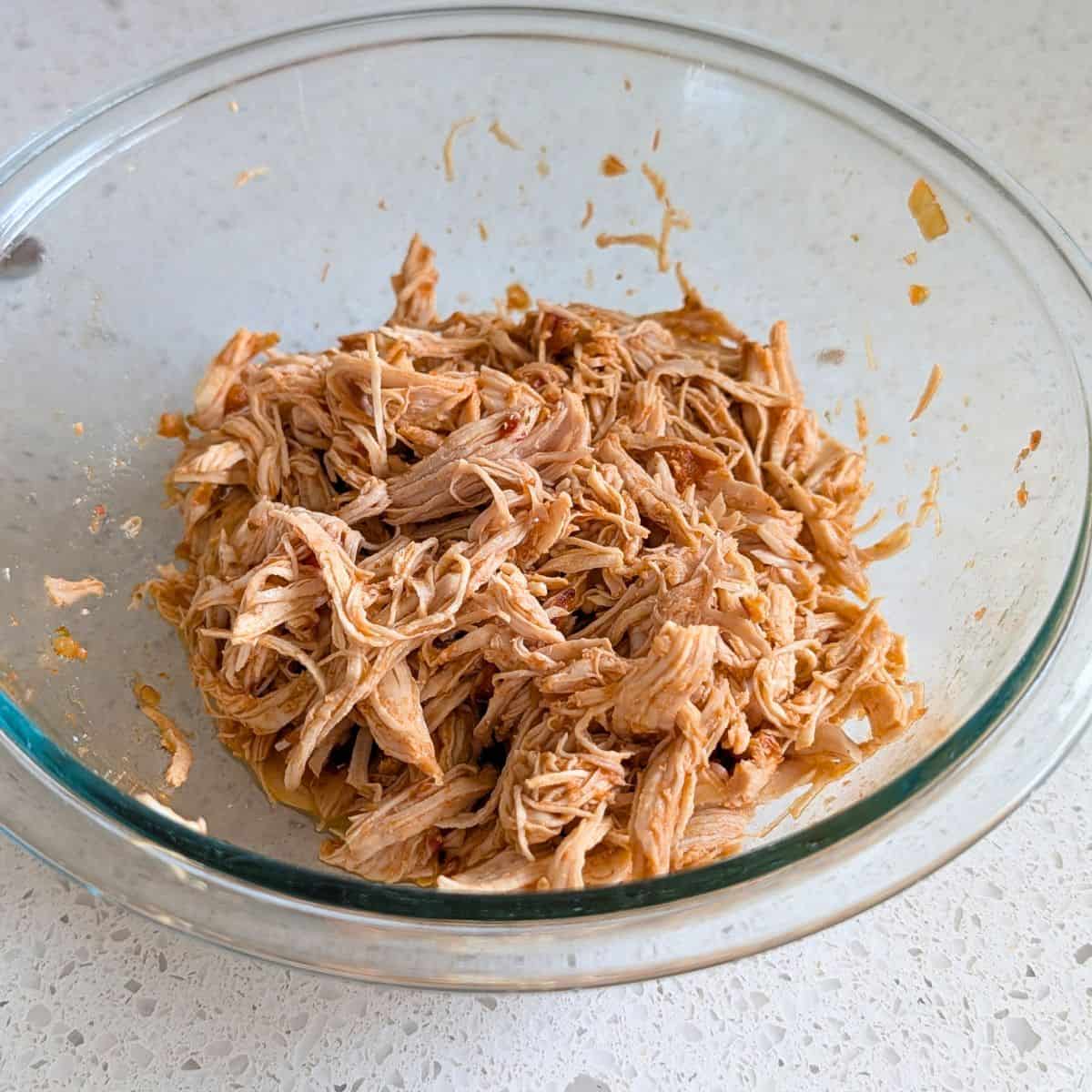 Shredded salsa chicken prepared as the filling for baked chile rellenos.