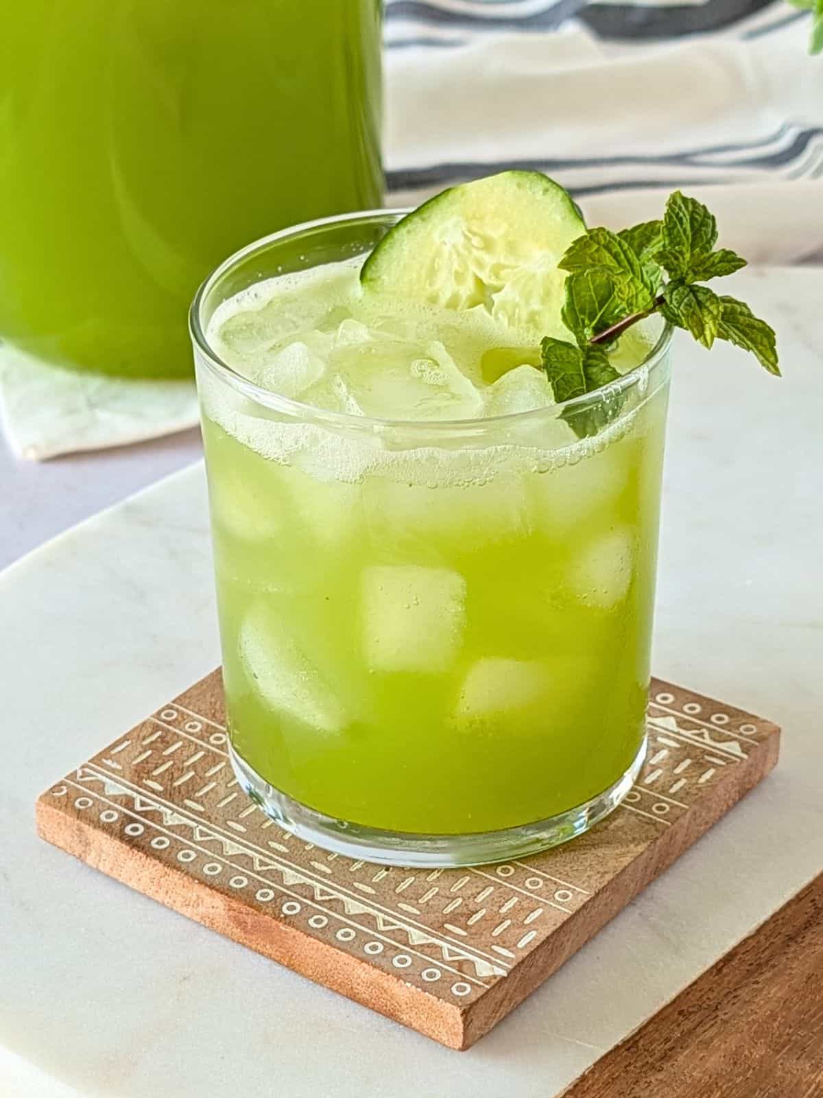 Glass of cucumber lime agua fresca served over ice.