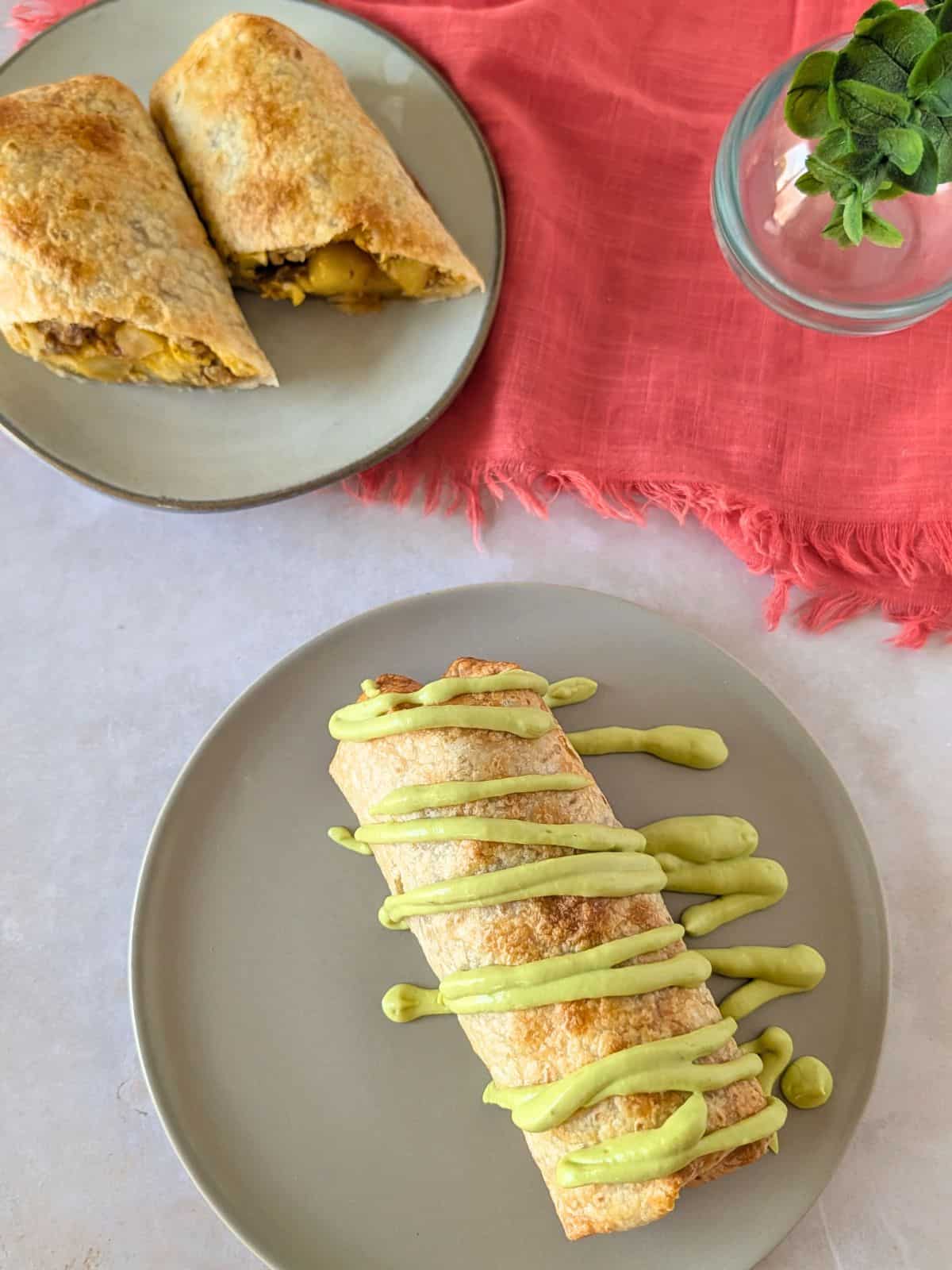 Overhead view of chimichangas on plates.