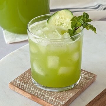 Glass of cucumber lime agua fresca served over ice.