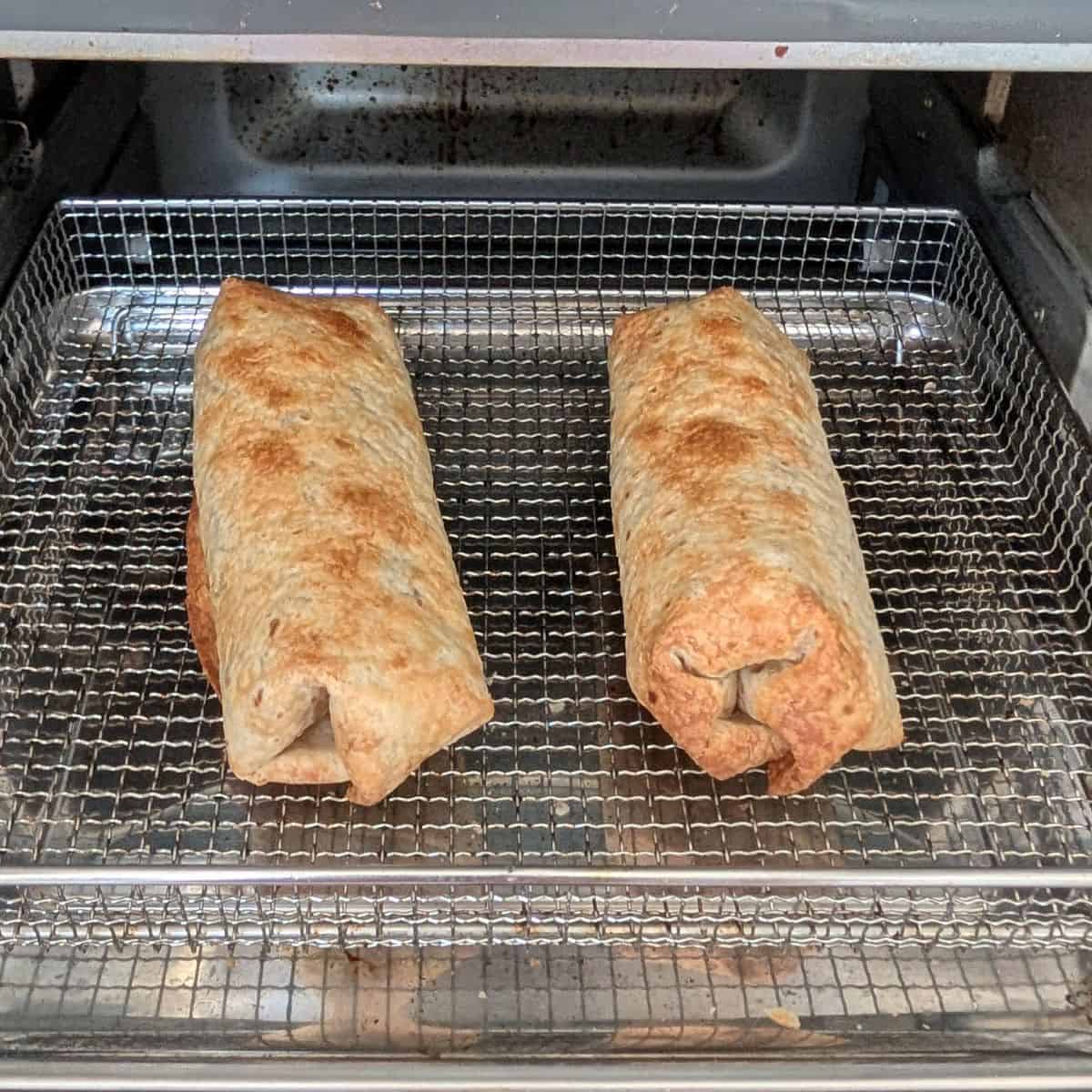 Air fried chimichangas on a tray.