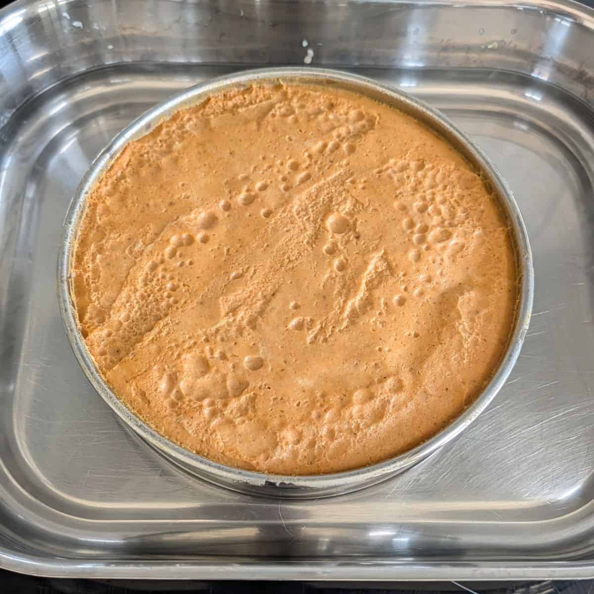 Cooked pumpkin flan in a cake pan.
