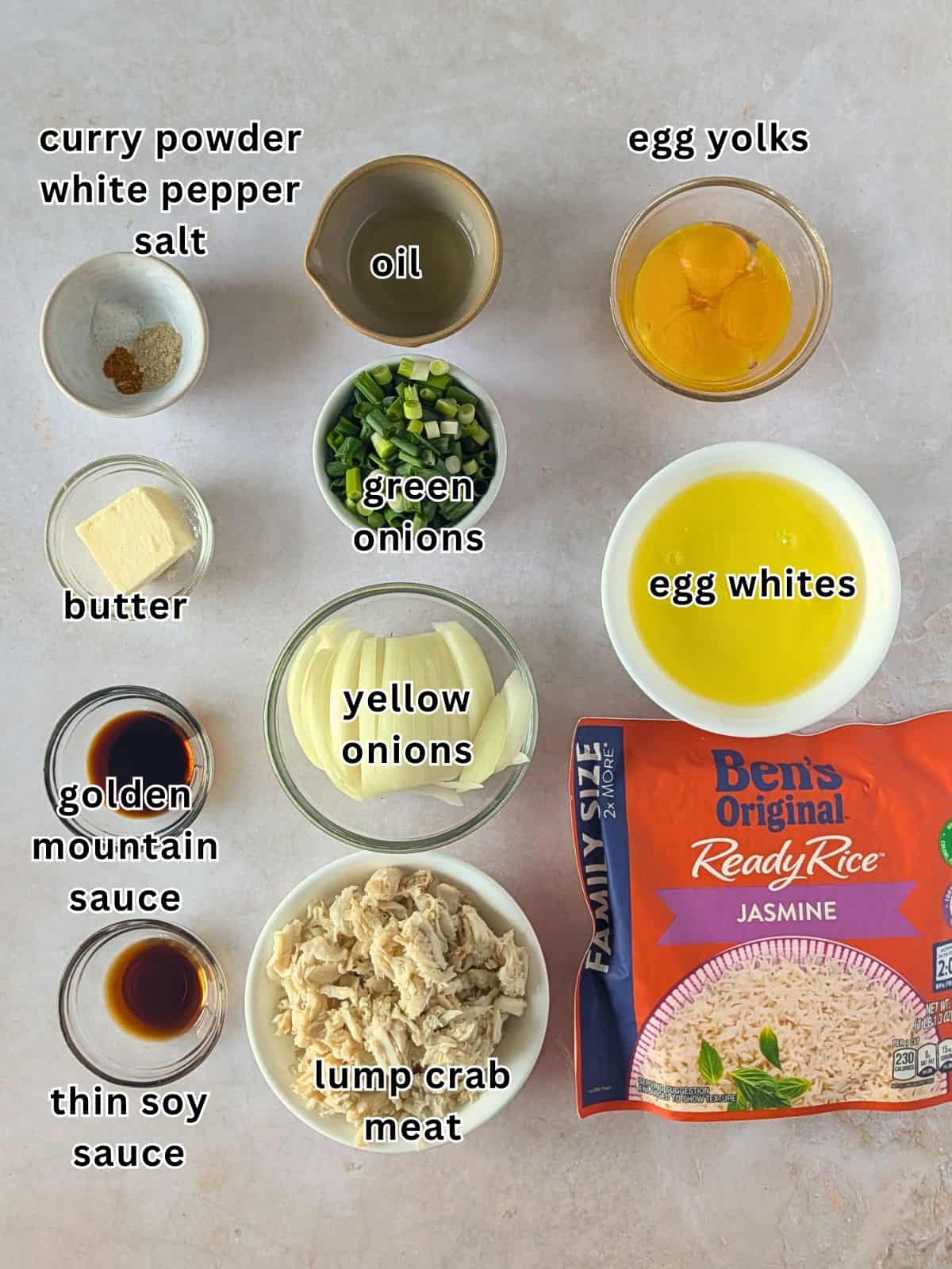 Ingredients for Thai Crab Fried Rice, including crab meat, jasmine rice, eggs, onions, butter, oil, and Thai seasonings.